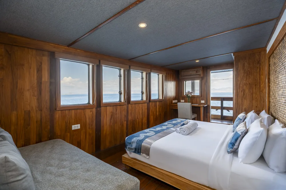 Double cabin with a king bed and sea view windows on Komodo Sea Dragon